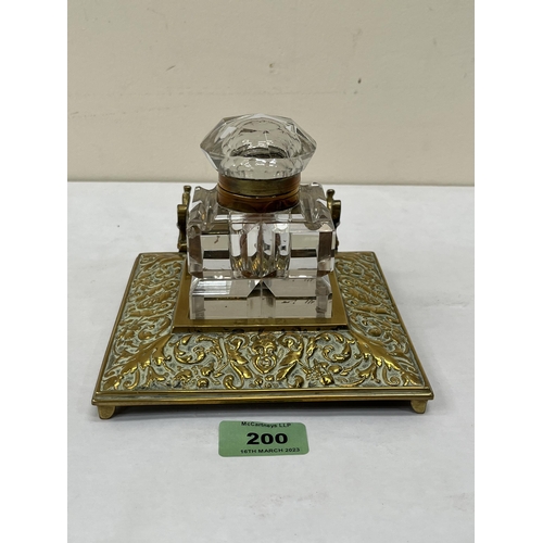 200 - A Victorian cast brass inkstand with cut glass well. 6' wide. Corner chips to well