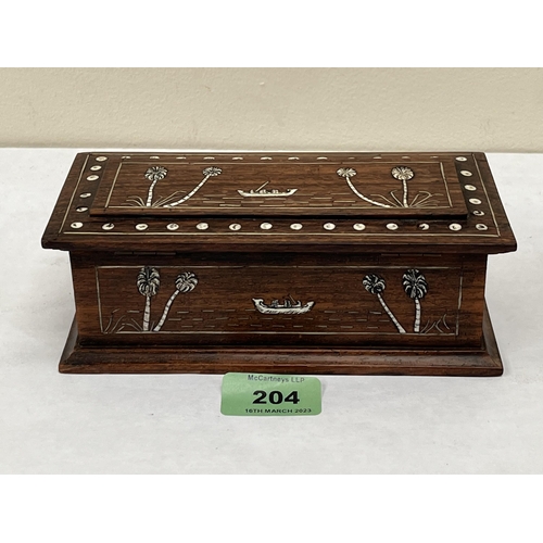 204 - An early 20th century bone inlaid treen box. 7' wide