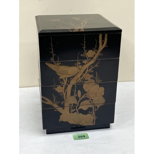 269 - A Japanese black lacquer box in four sections, gilded in low relief with birds and prunus. 7'w x 10¼... 