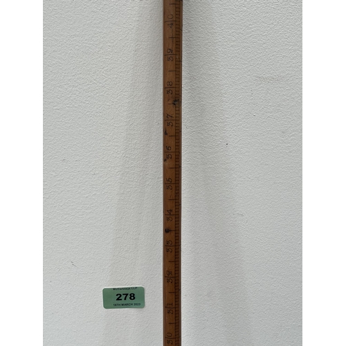 278 - A walking cane or dipper with measuring scale to the shaft. 42' long