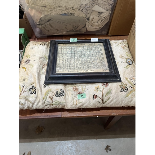 31 - An embroidered cushion and a facsimile multiplication table in frame