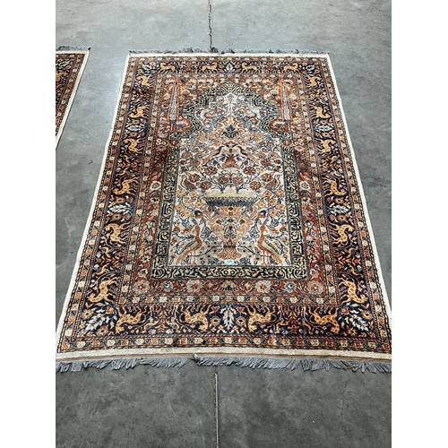 324 - A pair of Indian wool rugs. 77' x 52'