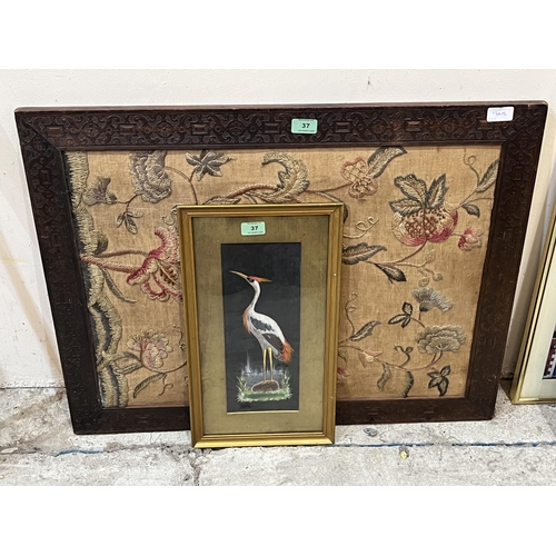 37 - An oak framed needlework and a feather picture of a crame