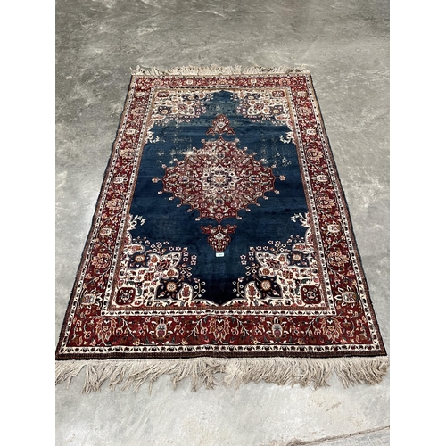 423 - A blue ground eastern rug. 81' x 51'