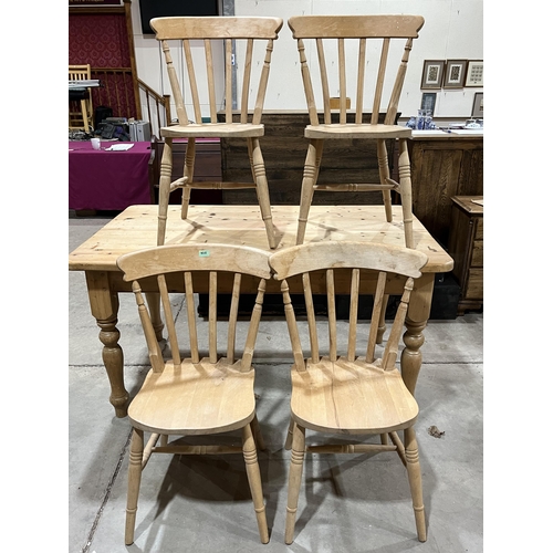 426 - A pine kitchen table on turned legs, 60' long; together with a set of four lath-back chairs