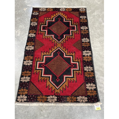 591 - A Baluchi rug. 1.37m x 0.81m