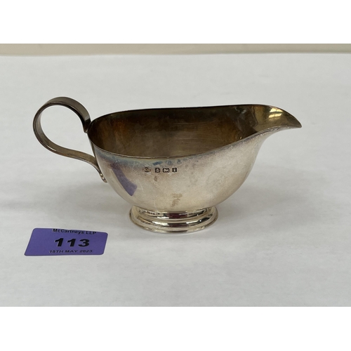 113 - An Edward VII silver cream jug. Birmingham 1908. 6' long over handle. 2ozs 17dwts