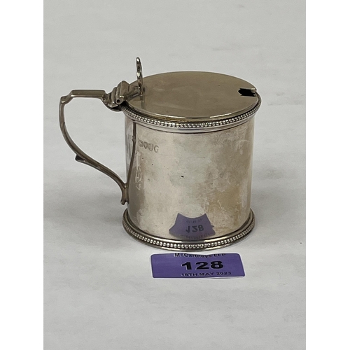 128 - A Victorian silver mustard pot with blue glass liner. London 1879. 3' high. 3ozs 17dwts