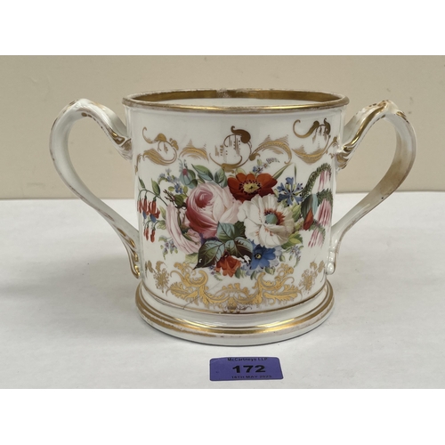 172 - A Victorian Staffordshire loving cup, one side painted with summer flowers, the other in gilt script... 