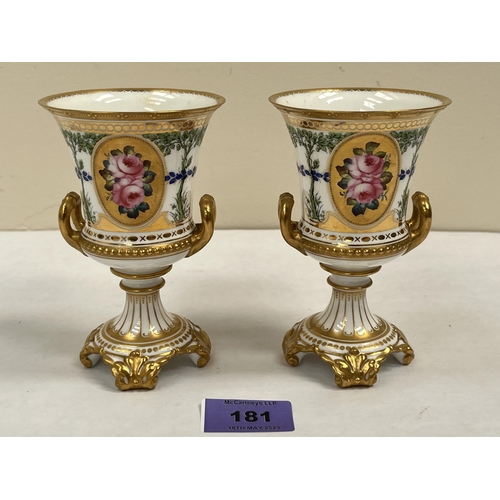 181 - A pair of Royal Crown Derby campana vases, gilded and painted with trees and vignettes of roses. 5' ... 