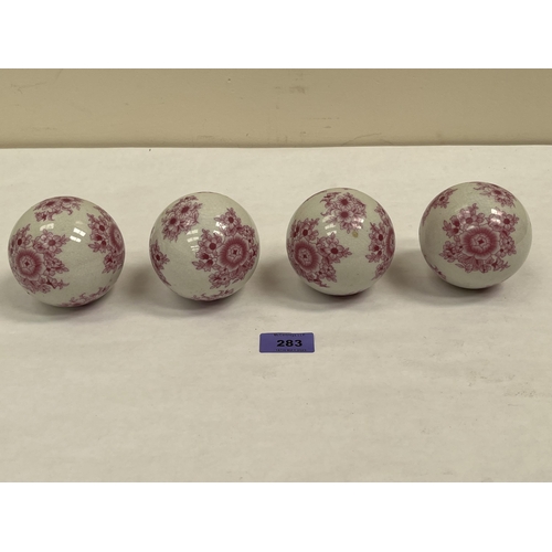 283 - A set of four late 19th century ceramic carpet bowls decorated with flower sprays. 3¼' diam approx.