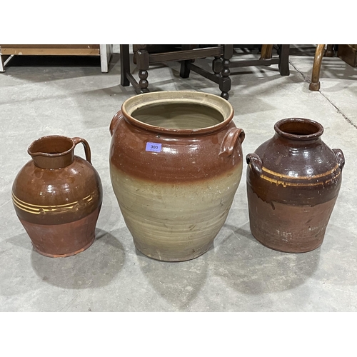 300 - Two glazed earthenware jars and a pitcher. 16½' high and smaller