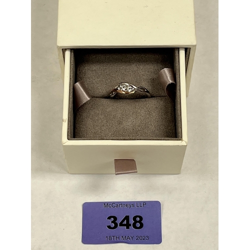 348 - A gold and silver Clogau ring set with three white sapphires. 2.1g gross. Size L