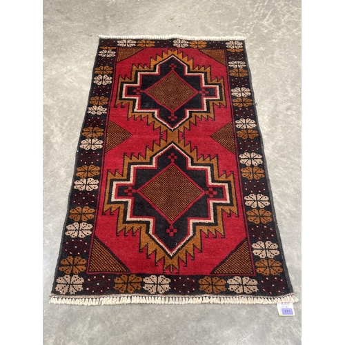 571 - A Baluchi rug. 1.37m x 0.81m