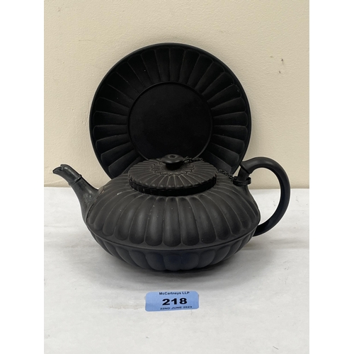 218 - An early 19th century Wedgwood black basalt teapot and stand, of compressed globular form with metal... 