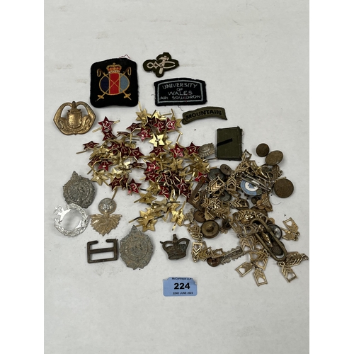 224 - A collection of military badges and buttons etc.