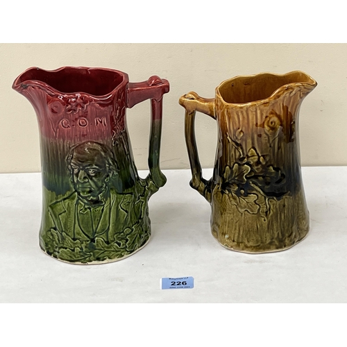 226 - Two 19th century majolica jugs, moulded in low relief with a male bust and oak leaves. The larger 9'... 