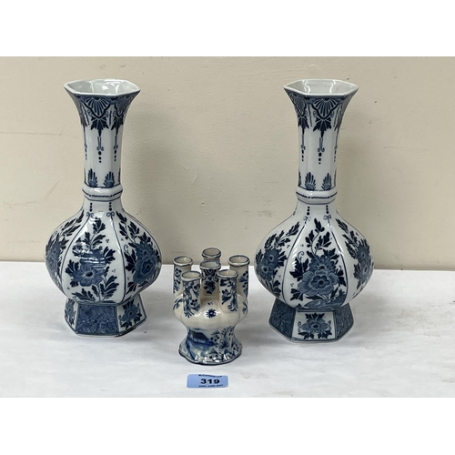 319 - A 19th century Dutch Delft tulip vase, 3¾' high and a pair of late Delft blue and white baluster vas... 