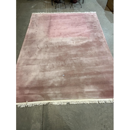 370 - A Chinese pink ground wool carpet. 108' x 144' approx.