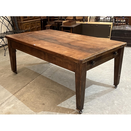 374 - A Victorian mahogany table, the cleated plank top over a frieze drawer on joined base and square tap... 