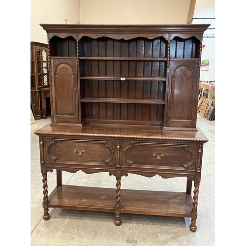 392 - A 1920s oak dresser with raised rack. 60'w x 72'h