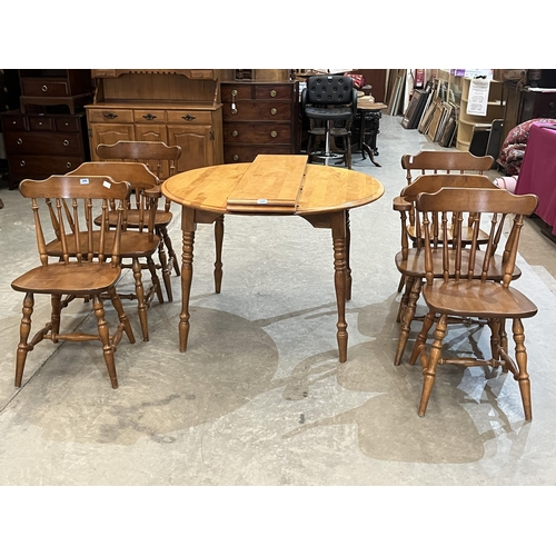 406 - A modern dining table, extending to 64' with two extra leaves, together with a set of six chairs