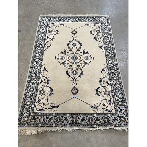 417 - A cream ground kashan rug