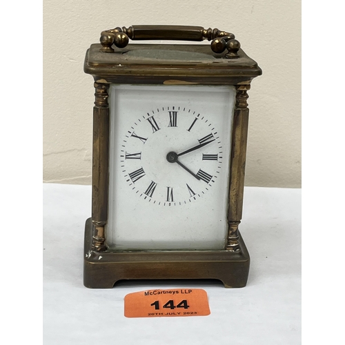 144 - An early 20th century French brass carriage timepiece. 4' high. Movement not running