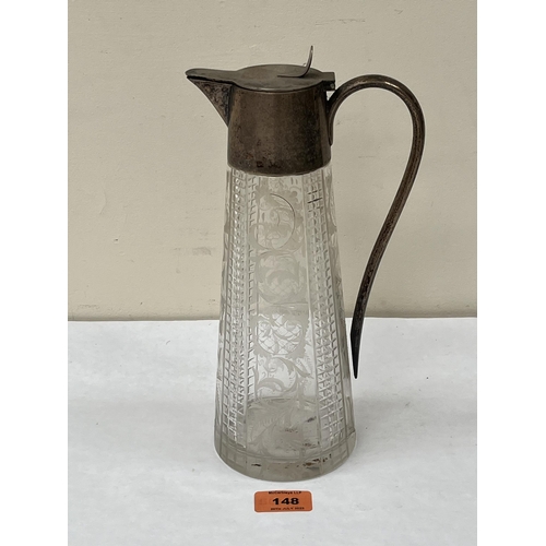 148 - A cut glass claret jug with plated mounts and handle. 11' high.