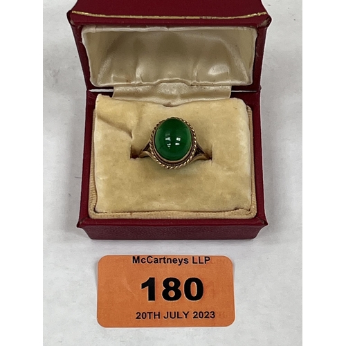 180 - A jade cabochon ring. In gold marked 375. 4g gross. Hoop broken