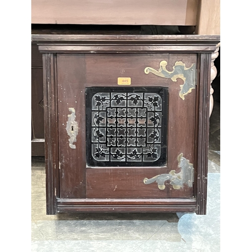 445 - A Victorian mahogany wall cupboard enclosed by an overlaid glazed door. 24' high