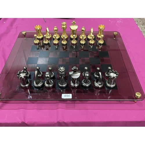 656 - A glass, brass and steel chess set 23½