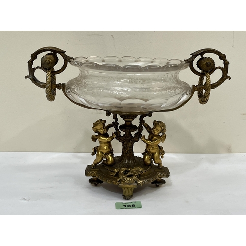 188 - A Napoleon III ormolu and etched glass table centrepiece, the base cast with two winged putti and fl... 