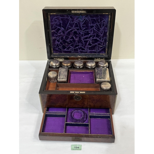 194 - A Victorian walnut and gilt brass mounted travelling vanity case, retaining a compliment of glass ja... 