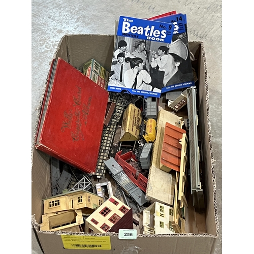 256 - A box of model railway, 1960s Beatles magazines and a album of cigarette cards.