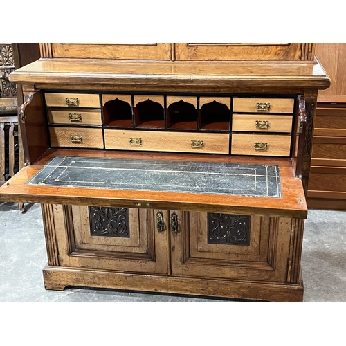 360 - A Victorian burr oak secretaire bookcase, enclosed by a pair of glazed doors, the base enclosed by a... 