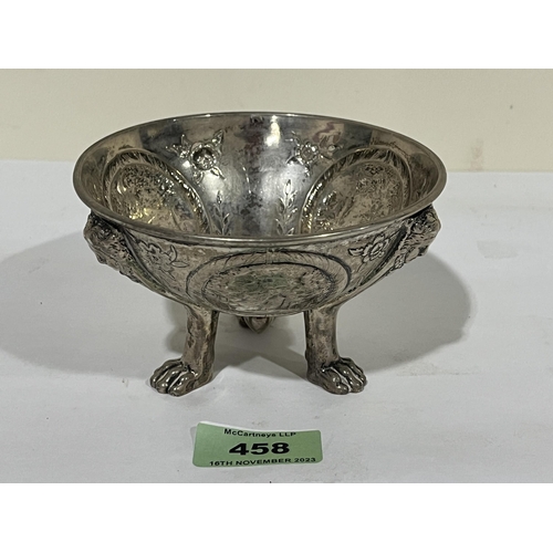 458 - A 19th century white metal bowl with chased decoration of landscape in reserves, on three paw feet. ... 