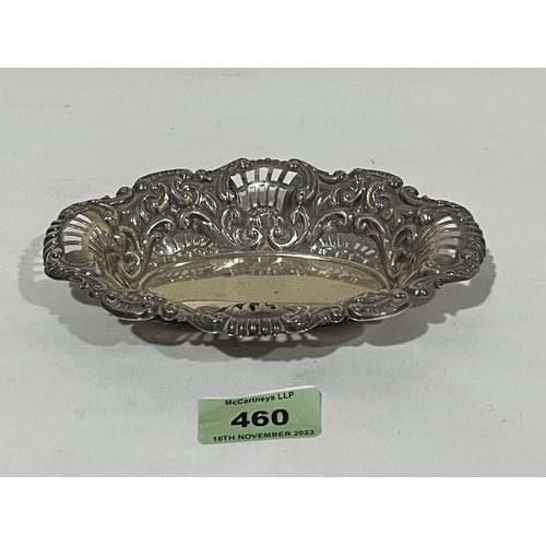 460 - A white metal pierced and repousse scroll decorated dish. 6¼