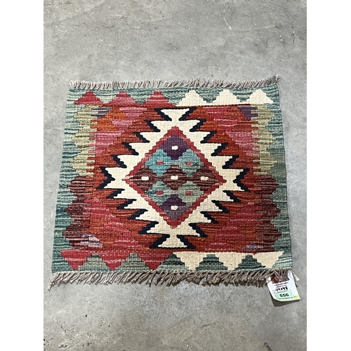 556 - A Chobi Kilim rug. 0.44m x 0.48m.