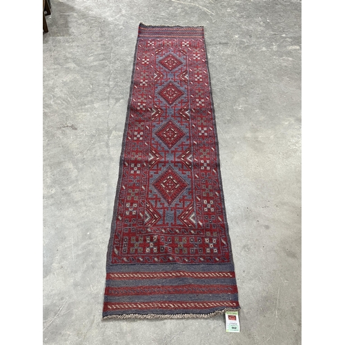 562 - A Meshwani carpet runner. 2.43m x 0.53m.