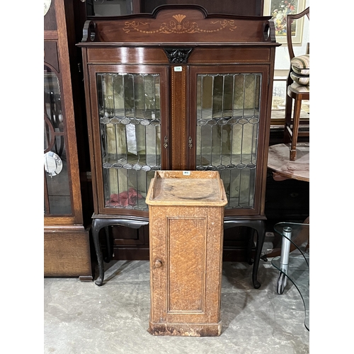 564 - An Edward VII mahogany and inlaid display cabinet enclosed by a pair of leaded glazed doors, on cabr... 