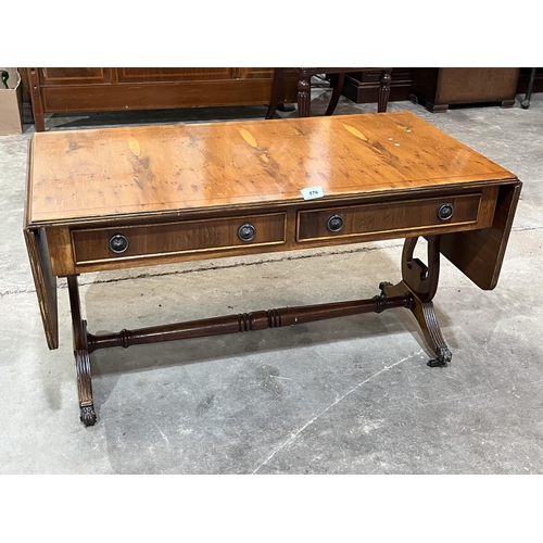 576 - A yew wood drop leaf low table with a pair of frieze drawers on lyre trestle supports. 38