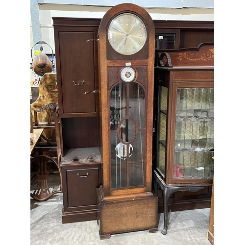 584 - A 1930s oak longcase clock, the two train weight driven movement striking and chiming on 8 tubular g... 