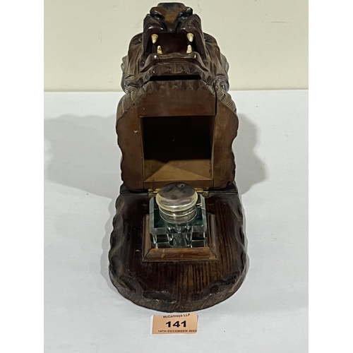 141 - A carved wood lion head inkwell. 5½