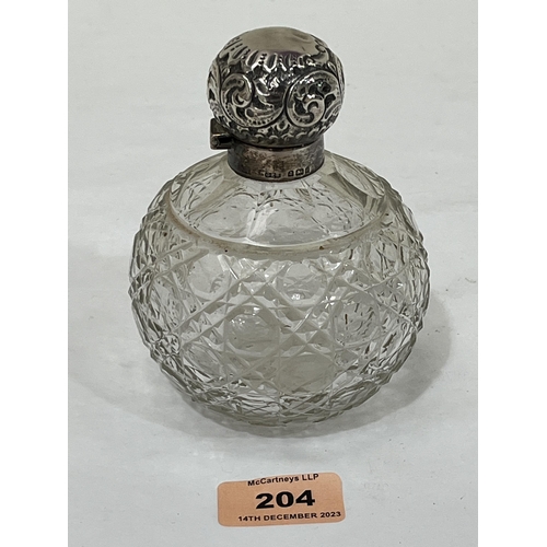 204 - An Edward VII globular cut glass scent bottle with silver mount and repousse lid. Birmingham 1903. 5... 