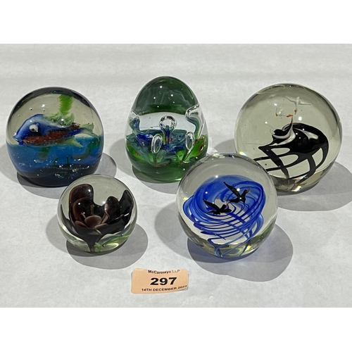 297 - Five glass paperweights.