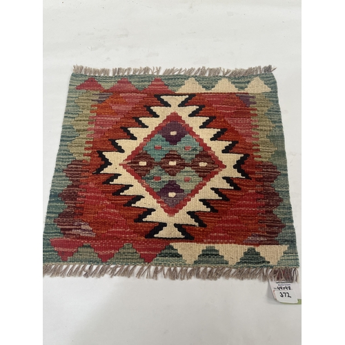 372 - A Chobi Kilim rug. 0.44m x 0.48m.