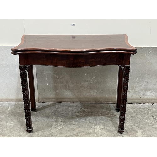 266 - A 19th century mahogany and crossbanded serpentine card table with small drawer to the back panel, r... 