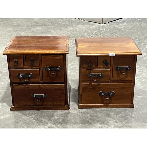 355 - A pair of Indonesian hardwood bedside chests of drawers. 17