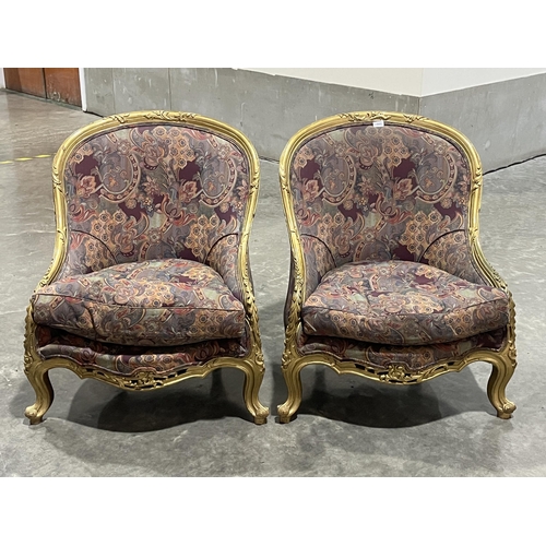 357 - A pair of giltwood and upholstered chairs in the French taste.